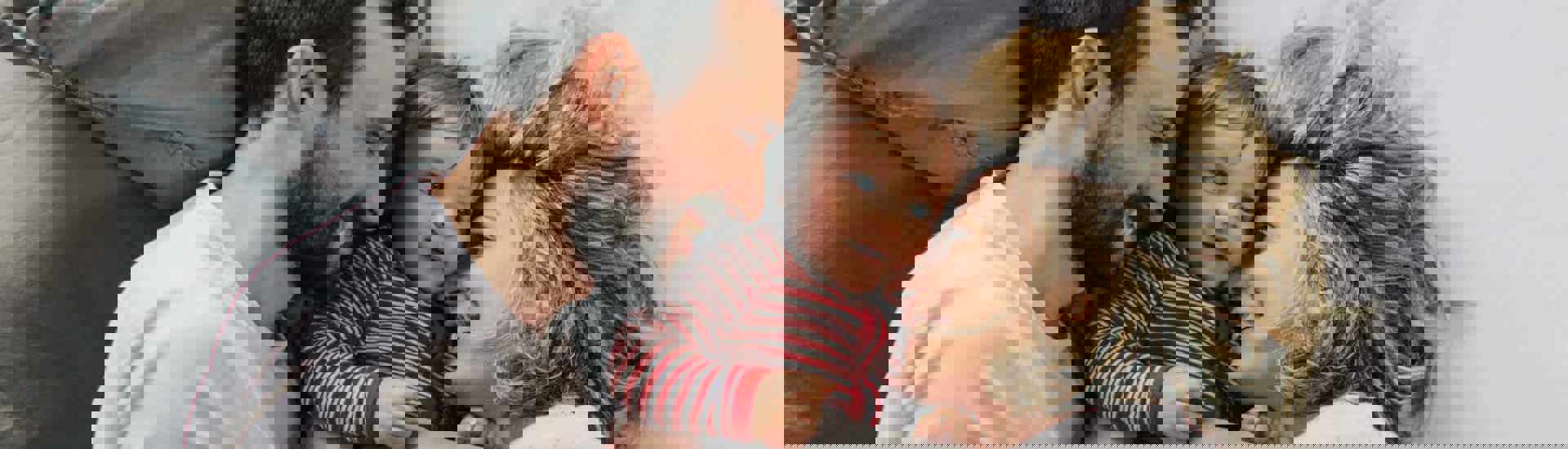 Koppel met baby in bed: voor de eerste keer ouder