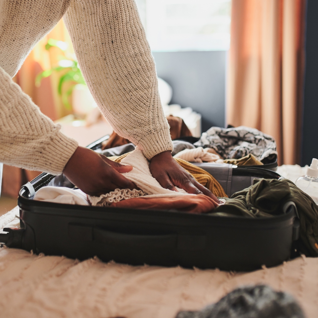 Vrouw pakt valies in huis veilig achterlaten bij vakantie